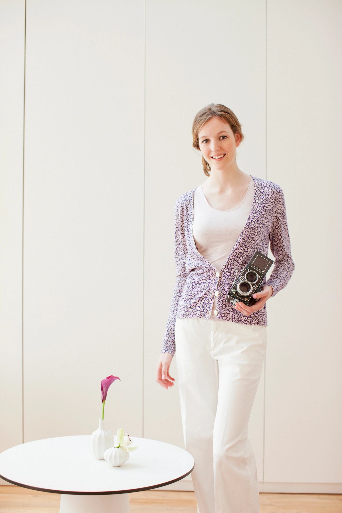 Female photographer smiling while holding a camera