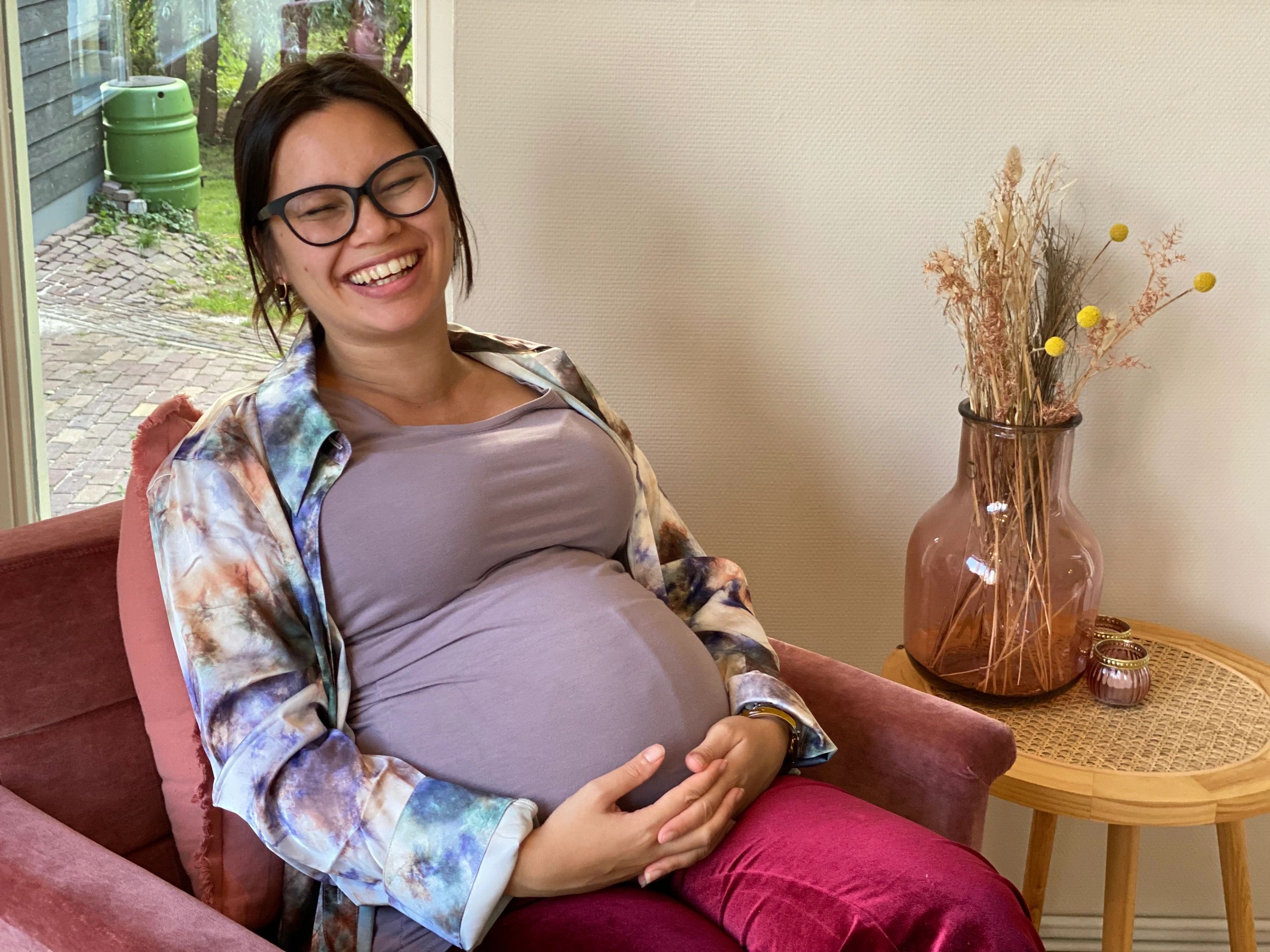 Seated maternity portrait with soft styling