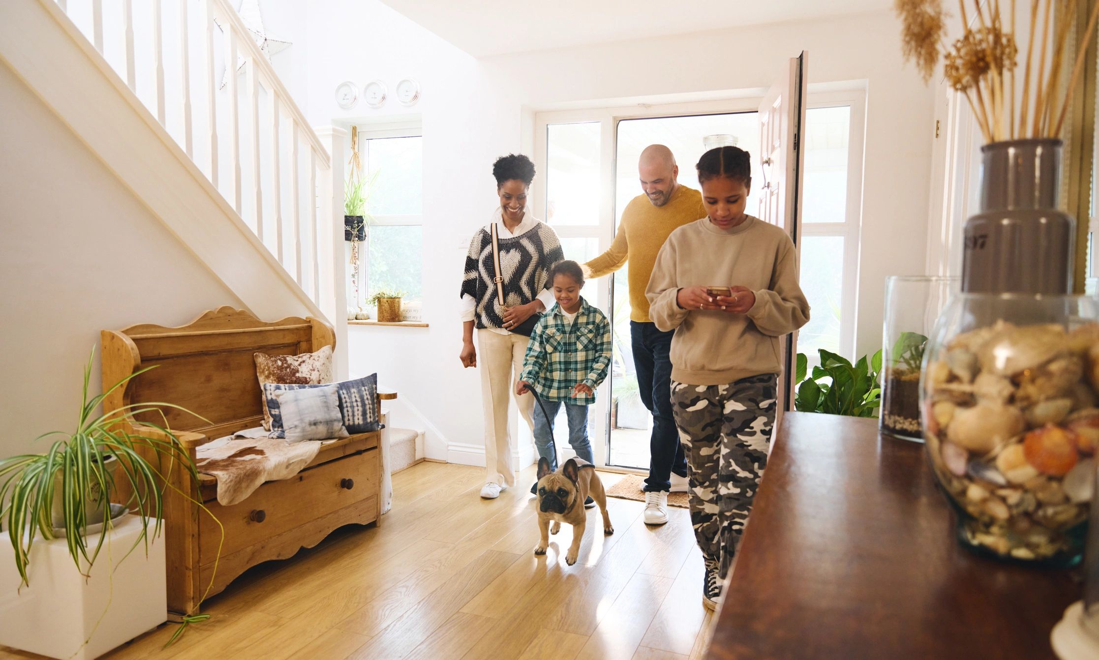 Family arriving home with their dog