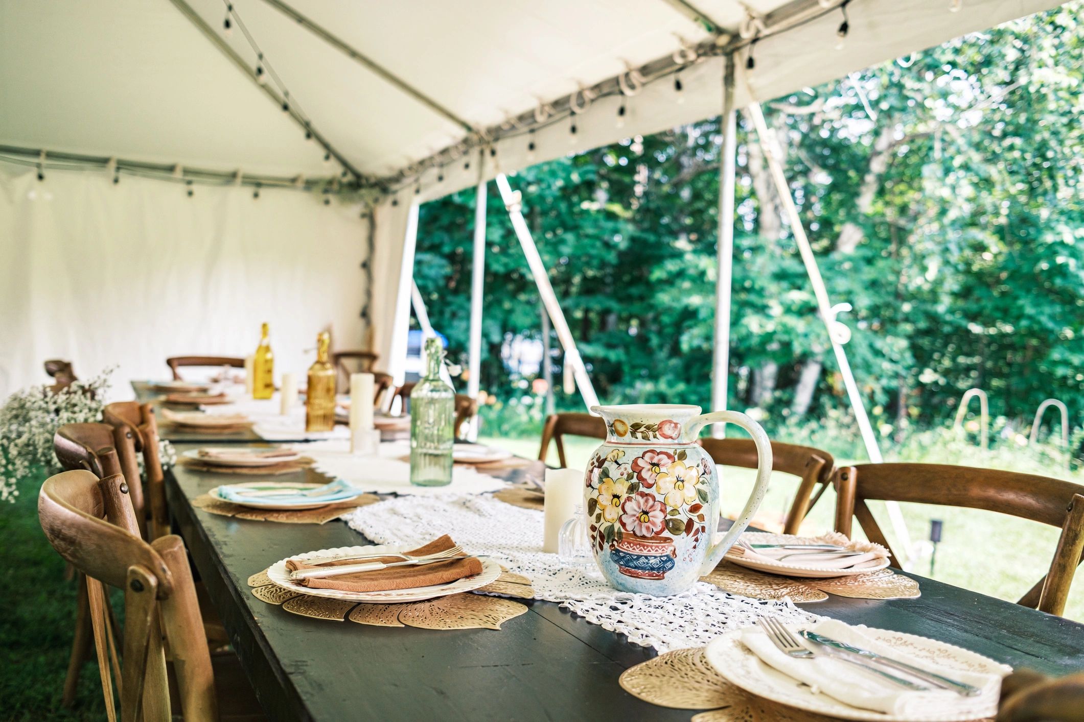 Elegant table setting inside a wedding tent