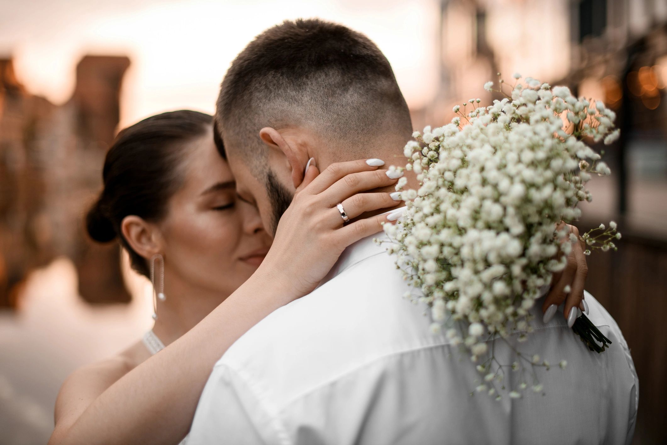 Bride embracing groom in close-up portrait