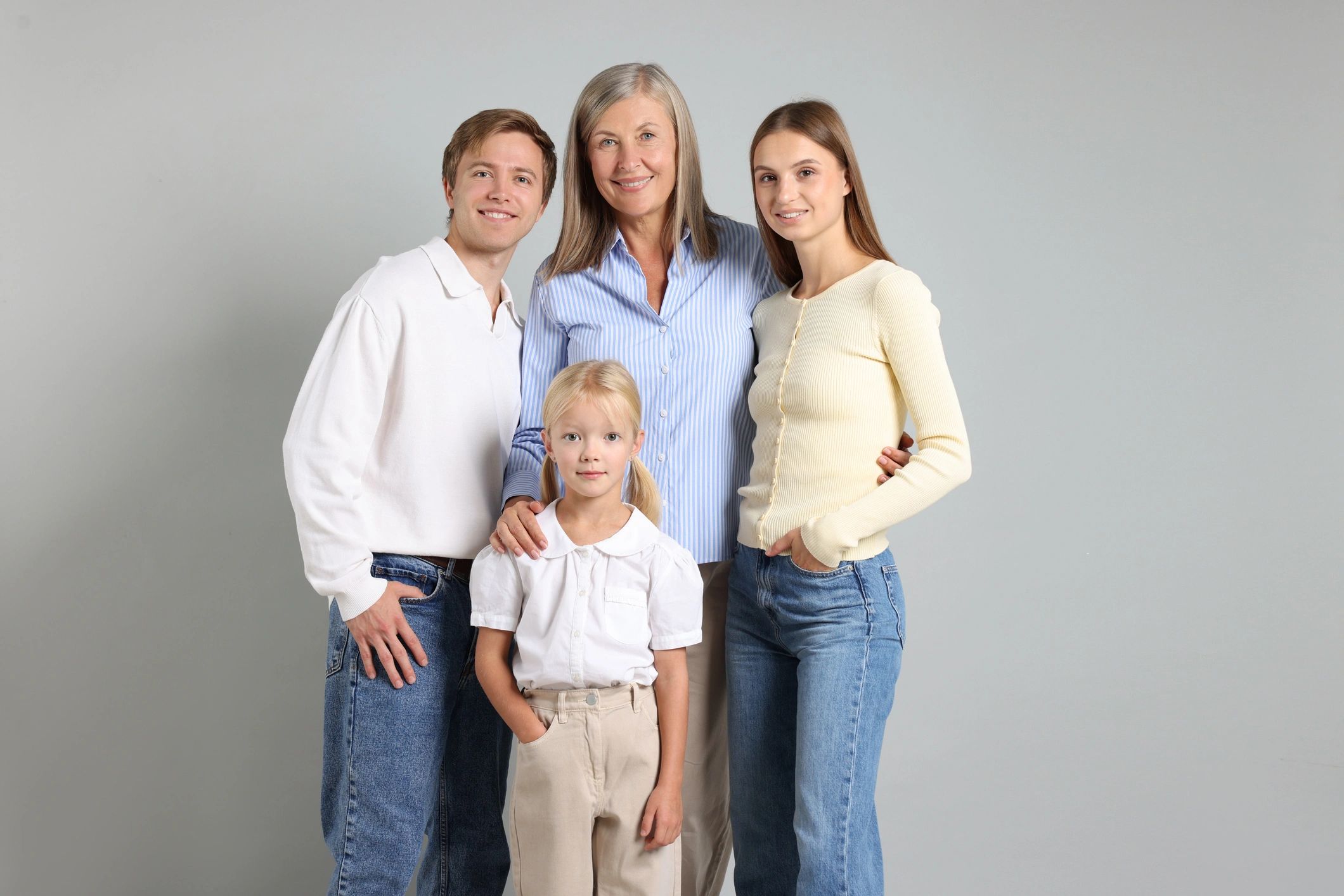Multi-generational family portrait on a light background